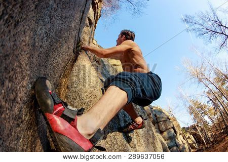 Rrock Shoe Close-up Of A Rock Climber Climbs A Boulder Over A Rock Without Insurance
