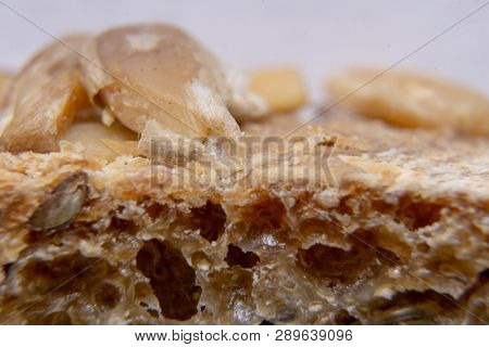 Bread crust with seeds macro. Bread extreme close-up.
