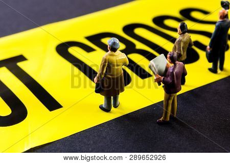 Do Not Cross Line With Little Miniature Figurines Standing In Front Of The Tittle And Looking At It,