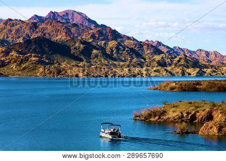 March 4, 2019 In Lake Mojave, Az:  People Boating On The Calm Waters Of Lake Mojave, Az Surrounded B