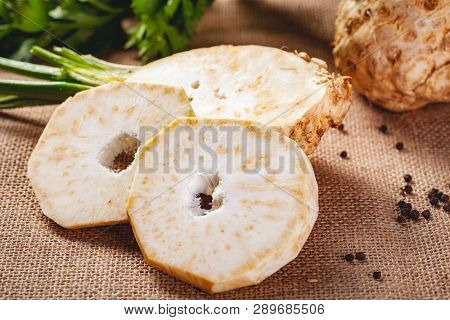 Celery Root With Leaves On Sackcloth Background. Close Up
