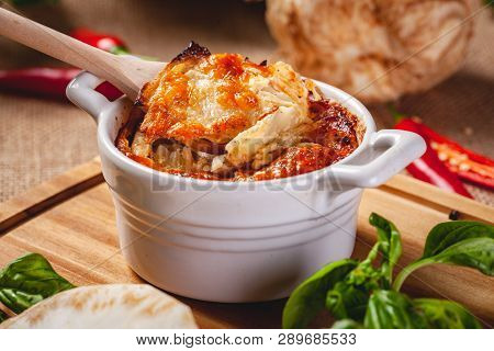 Celery Root Gratin With Cheese And Mushrooms On Wooden Board. Close Up