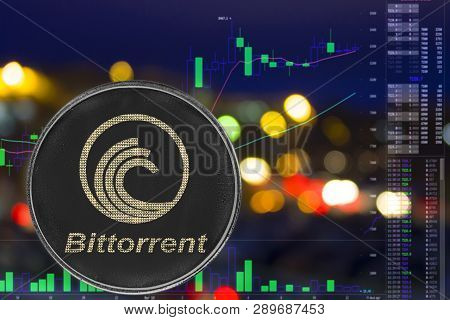 Coin Cryptocurrency Bittorrent On Night City Background And Chart. Btt