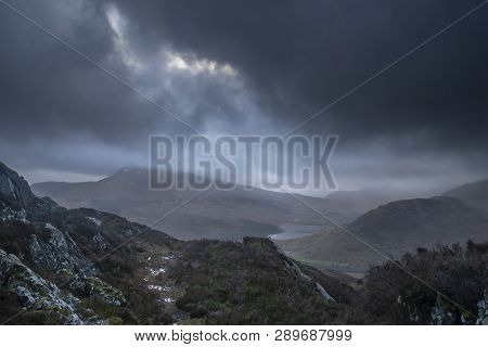 Dark And Dramatic Winter Landscape Image Of Moel Saibod From Crimpiau In Snowdonia With Stunning Sha
