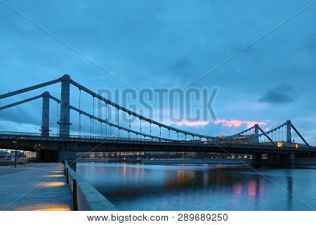 Krymsky Bridge Or Crimean Bridge  Across The Moskva River In Moscow In The Rays Of Setting Sun In Th