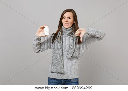 Irritated Woman In Gray Sweater, Scarf Showing Thumb Down Hold Medication Tablets Aspirin Pills In B