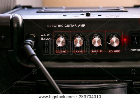 Guitar Amplifier With Dials And Controls For Volume, Gain, Bass, Treble. Jack Cable Connected. Black
