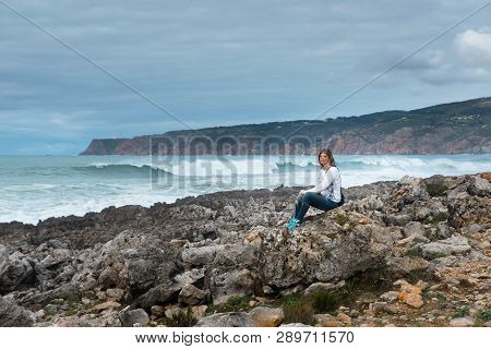Woman, Girl Sitting On The Atlantic Ocean