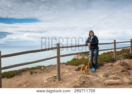 Woman, Girl Stands On The Shore Of The Atlantic Ocean