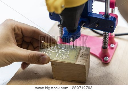 Young Male Doing Holes In Electrinic Or Silicon Plate Circuit Board