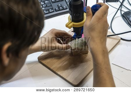 Young Male Doing Holes In Electrinic Or Silicon Plate Circuit Board