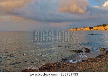 Calm Sea With Clouds Hanging Over It