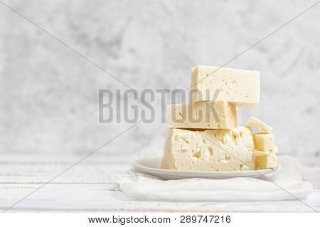 Sliced Feta Cheese On Light Background. High Key. With Copy Space.
