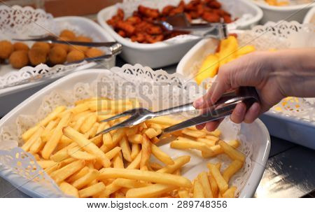 Tray With Many Yellow Hot Fries In The Self-service Restaurant