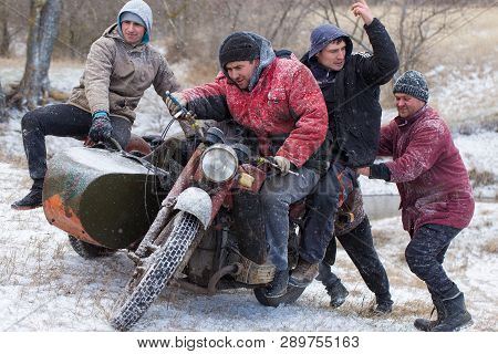 Taraclia, Moldova - 23. 02. 2019: A Team On A Soviet Retro Motorcycle With A Sidecar In The Mud And 