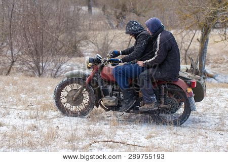 Taraclia, Moldova - 23. 02. 2019: A Team On A Soviet Retro Motorcycle With A Sidecar In The Mud And 