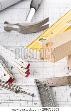 Construction Tools And Wooden Strips On Architectural Blueprint House Building Plan On Table
