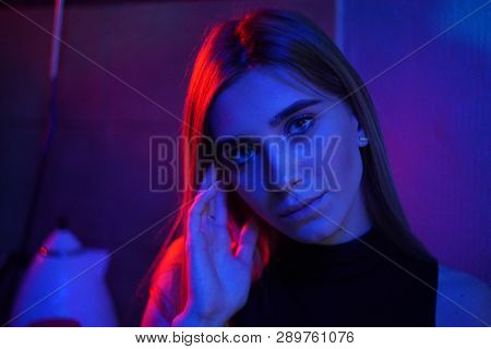 Sexy Young Beauty Woman Posing Over Night City Dramatic Red And Blue Neon Background