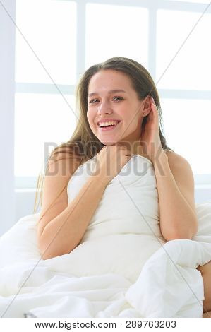 Young Caucasian Woman Covering Her Head And Ears With Pillows