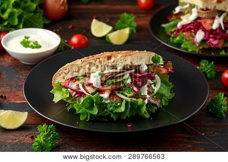 Doner Kebab, Fried Lamb Meat With Vegetables And Garlic Sauce In Turkish Bread