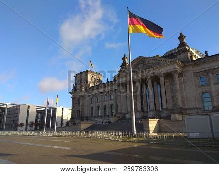 Germany Flag At At Berlin Parliament With A Blue Sky