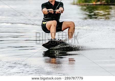 Wakeboarding In Summer On Lake Male Wakeboarder In Black Swimsuit