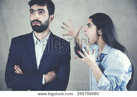 Couple Having Arguement At Home On Dark Background