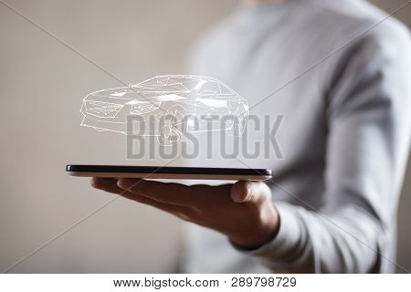 Man Hand Phone And Car Model In Screen