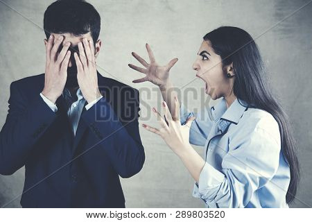 Couple Having Arguement At Home On Dark Background