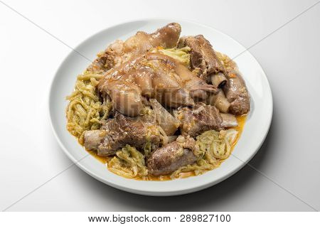 White Plate With Pork Meat And Savoy Cabbage
