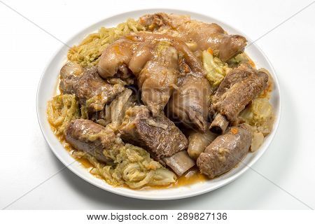 White Plate With Pork Meat And Savoy Cabbage