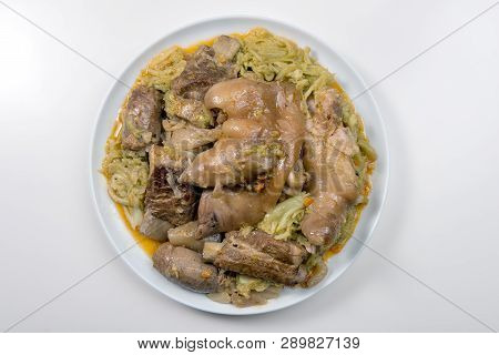 White Plate With Pork Meat And Savoy Cabbage