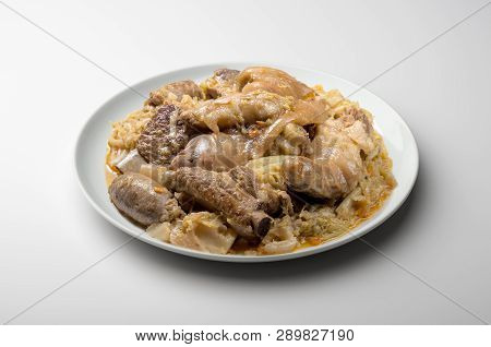 White Plate With Pork Meat And Savoy Cabbage
