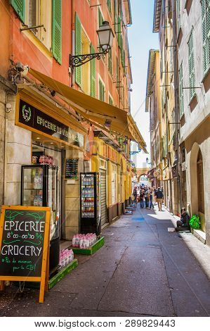 Nice, France - April 18 2017. Colorful Narrow Street In Nice, French Riviera. Souvenir Shops And Tur