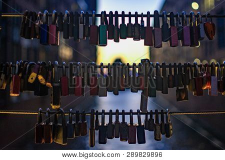 Locks Of Love Blury Lights Background On Valentines Day. Wedding Locks On Rope Bridge Lock Symbol At