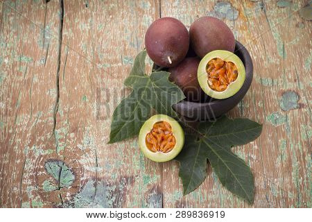 Fruits Of Gulupa On Vine Wood Table, Passiflora Pinnatistipula