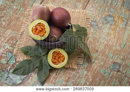 Fruits Of Gulupa On Vine Wood Table, Passiflora Pinnatistipula