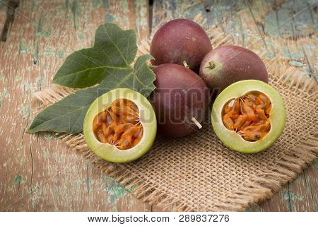 Fruits Of Gulupa On Vine Wood Table, Passiflora Pinnatistipula