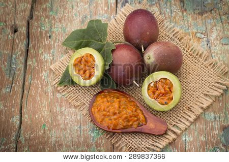 Fruits Of Gulupa On Vine Wood Table, Passiflora Pinnatistipula