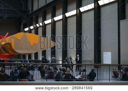 London, Uk - April 01: Visitors Sit Under The Artwork 