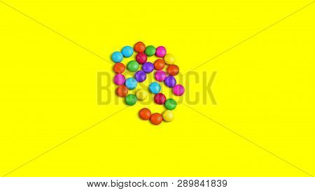 Colorful Chocolade Smarties On The Yellow Background.