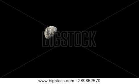 Only Half Of The White Moon Floats In The Black Sky.