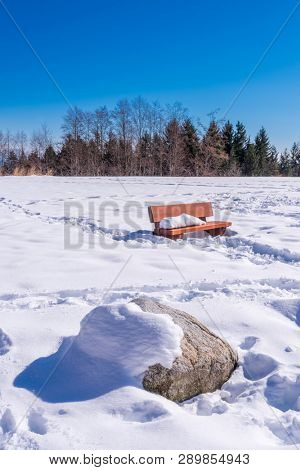 A park bench with gorgeous view at mountains and blule sky with white clouds, British Columbia, Canada.