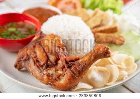 Nasi lemak kukus with fried drumstick, popular traditional Malaysian local food.