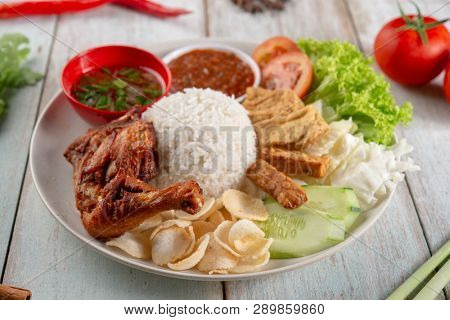 Nasi lemak kukus with fried drumstick, popular traditional Malaysian local food.