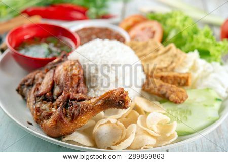 Nasi lemak kukus with fried drumstick, popular traditional Malaysian local food.