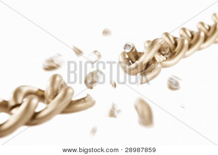 Broken link of golden chain with blurry movement of the scattered pieces, isolated against white background. small depth of field