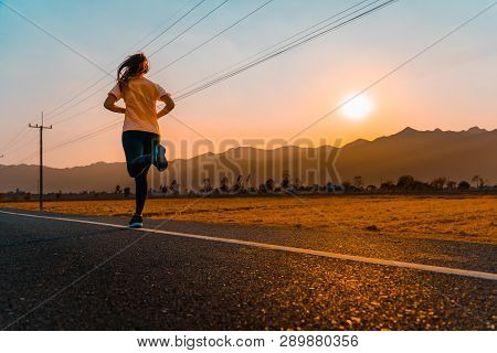 Asian Woman Enjoys Running Outside With Beautiful Summer Evening In The Countryside.