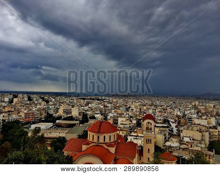 A Big City Under A Dark Blue Sky Above It