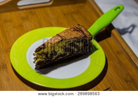 Delicious Homemade Chocolate Cake With Cottage Cheese On The Wooden Table Background. A Piece Is Cut